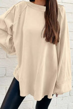 Beige oversized long sleeve crewneck sweatshirt with raglan sleeves and relaxed fit machine wash tumble dry care instructions