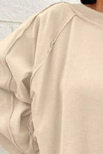 Beige oversized long sleeve crewneck sweatshirt with relaxed fit and ribbed cuffs machine wash tumble dry care instructions