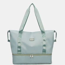 Oversized nylon travel duffel bag in two-tone light blue with metallic accents