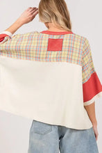 Woman in oversized plaid star patch t-shirt with fig round neck and denim shorts