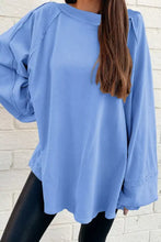 Light blue oversized washed crewneck sweatshirt with relaxed fit ribbed cuffs machine wash tumble dry care instructions