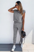 Gray padded shoulder top with ruffled shoulders and matching joggers lounge set paired with white sneakers and brown backpack