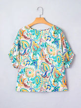 A vibrant paisley floral printed puff sleeve blouse with colorful teal yellow and blue patterns on white fabric
