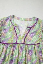 Paisley print half puff sleeve blouse in light green and purple with a v-neckline trimmed in deep purple piping