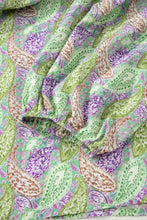 Paisley print half puff sleeve blouse made of soft flowing fabric with vibrant green purple and brown paisley pattern
