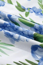 White fabric neck short sleeve blouse with vibrant blue hydrangea green leaf striped patchwork design