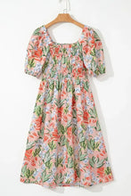 Pastel floral print summer dress with puff sleeves and square neckline on peach background