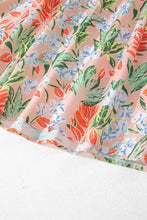 Pastel floral print summer dress with peach orange flowers, green leaves, and ruffled puff sleeves