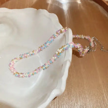 Pastel titanium steel rice bead necklace with adjustable silver chain clasp in white ceramic bowl
