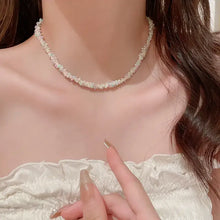 Pearl choker with titanium steel rice bead chain, floral accents, gold clasp