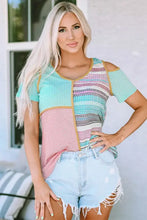 Woman in patchwork round neck cold shoulder short sleeve top with denim shorts
