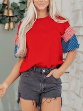 Patriotic short sleeve round neck top with red ruffled patchwork sleeves featuring white stripes and blue star print
