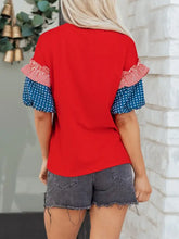 Patriotic short sleeve round neck top in red with ruffled sleeves featuring red white stripes and blue polka dots