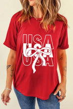 Patriotic USA bow graphic on red t-shirt with white USA design
