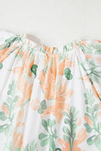 Peach and green floral ruffled romper with off-shoulder top on white background