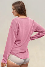 Peach ribbed long sleeve knit top with dolman sleeves and pocket