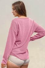 Peach ribbed long sleeve knit top with dolman sleeves and pocket