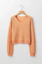 Peach V-neck long sleeve waffle knit top with ribbed cuffs