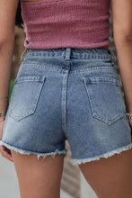 Pearl beaded raw hem denim shorts with light wash and frayed hems