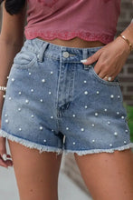 Pearl beaded raw hem denim shorts with light wash and frayed edges