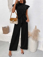 Pearl detail ruffled cap sleeve jumpsuit with black ruffles and pearls