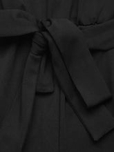 Black belt knotted at waist of pearl detail ruffled cap sleeve jumpsuit