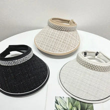 Three pearl-embellished sunscreen hats in black, beige, and white