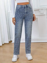 Light-wash denim high waist straight jeans with white pearl embellished high waist polka dot design