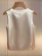 A sleek off-white pearl embellished satin tank top with a rounded neckline and clean seams