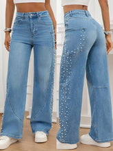 Light blue denim pearl embellished wide leg jeans showing the back side with pearls on seams and back pocket