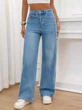 Light blue denim pearl embellished wide leg jeans with pearls running down the outer seams