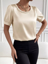 Cream satin pearl trim bodysuit with short puffed sleeves and elegant pearl trim neckline