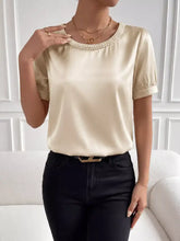 Cream satin pearl trim satin blouse with a pearl-trim neckline and puffed short sleeves for elegant wear