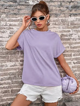 Young woman in Perfee Round Neck T-Shirt, lavender bag, denim shorts