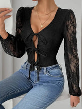 Perfee tied lace black lace long sleeve bodysuit with deep v-neck and front tie details for elegant wear