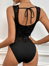 Black lace perfee tied open back sleeveless bodysuit with smooth fabric and tied-back design showing the back side