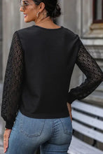 Perfee twisted decorative button long sleeve T-shirt with sheer lace sleeves and blue jeans