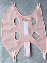 Pink mesh pet grooming hammock with elastic edges for nail trimming