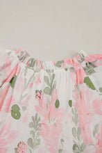 Pink and white floral print romper with ruffled hem, pockets, and pink, green, gray accents on white background