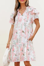 Pink floral ruffle romper with short sleeves, hem, and pockets