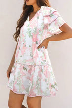 Pink and white floral print romper with ruffled hem and pockets
