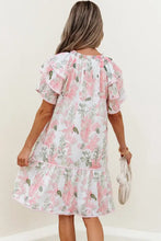 Pink floral print ruffled romper with short sleeves, tiered skirt, hem, and pockets