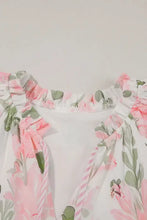 Pink floral print romper with ruffled hem, pockets, and elastic waistband