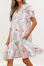 Pink and white floral print romper with ruffled hem and pockets