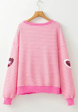 Pink and white striped long-sleeve sweatshirt with glitter heart accents