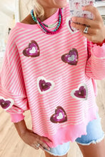 Pink and white striped sweatshirt with glittery metallic heart accents