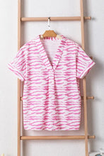 Pink and white zebra stripe womens polyester shirt on wooden hanger