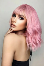 Woman in pink bobo wave synthetic wig with bangs, heat safe