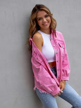 Pink distressed drop shoulder denim jacket with frayed edges and button closure