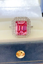 Elegant pink sapphire ring in 18k white gold with diamond halo and sterling silver accents